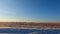 Beautiful panorama of the endless Kazakh steppe. Small village. Traveling by car along the highway in Kazakhstan. Warm sunny winte