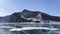 Beautiful panorama of frozen Lake Baikal. Stone, forested rocks, mountains and hills of Olkhon Island