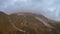 A beautiful panorama with the high mountains that reach the clouds and the sounds of the bells of grazing cows