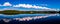 beautiful panorama with a long cloud reflected in the lake