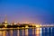 Beautiful panorama of Riga center over Daugava river with St Peters Church and railroad bridge during amazing sunset. View of illu