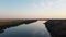 Beautiful panorama of river going to horizon and reflecting blue sky. Footage. River surface reflects beautiful blue sky