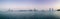 Beautiful panorama shot of Abu Dhabi city skyline towers and beach at sunset