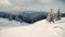 Beautiful panorama of snowy mountains landscape with snow covered forest.