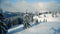 Beautiful panorama of snowy mountains landscape with snow covered forest.