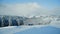 Beautiful panorama of snowy mountains landscape with snow covered forest