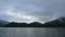 Beautiful panorama video view of morning reservoir lake water lush tropical mountain forest with cloud and fog 4k