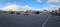Beautiful panorama view of car parking place on blue sky with white clouds background.