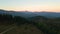 Beautiful panoramic mountain landscape with hazy peaks and foggy valley at sunset