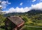 Beautiful panoramic postcard view of picturesque rural mountain scenery in the Alps with traditional old alpine mountain chalets