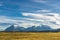 Beautiful panoramic view of golden yellow grass with background of nature cuernos mountains peak with cloud in autumn, Torres del