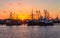 Beautiful, panoramic view on old fishing trawler on the Harbour of Romo RÃ¸mÃ¸ Havn during sunset. In the Background old ships,