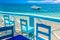 Beautiful panoramic view point with blue chairs and a ship. Vacation background. Idyllic beach landscape in Samana, Dominican