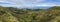 Beautiful panoramic view of the Sao Miguel Azores island nature with lush green fields, tree and hills and ocean on the