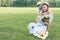 beautiful parent and daughter with fruits in wicker basket and flower bouquet sitting