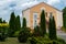 Beautiful park and botanical garden. Tall thuja trees in the courtyard of a country cottage in the summer