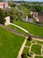 Beautiful park in Victorian style with beautiful lawn paths and decorations in the form of green pyramids