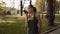 Beautiful passionate mixed race girl sends voice messages. sports girl in the park.4K