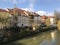 Beautiful pastel buildings along the riverbank in Slovenia.