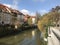 Beautiful pastel buildings along the riverbank in Slovenia.