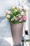 Beautiful patio pot with floral arrangements: roses, petunias and verbenas flowers on balcony or terrace. Urban Container planter