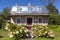 Beautiful patrimonial pale yellow brick country house with silver metal roof and dormer windows