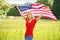 Beautiful patriotic young woman with American flag
