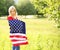 Beautiful patriotic young woman with American flag