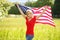 Beautiful patriotic young woman with American flag