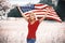 Beautiful patriotic young woman with American flag