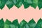 Beautiful pattern from fresh green ivy leaves arranged in top and bottom border frame on light pink background. Banner Poster