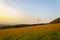 Beautiful and peaceful field with electrical transmitters during sunny day