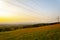 Beautiful and peaceful field with electrical transmitters during sunny day