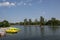 Beautiful peaceful nature, trees and plants on a lake, floating bird house, public park with pedal boats, reflection in the water