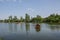 Beautiful peaceful nature, trees and plants on a lake, floating bird house, summertime season, reflection in the water