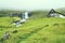 Beautiful peaceful rock house with green grass on the roof in Saksun valley next to the waterfall in foggy weather, Faroe Islands