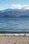 Beautiful pebble beach facing mountains with snow