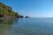 Beautiful pebble beach in a picturesque bay with clear blue water