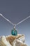 Beautiful pendant with chain made of silver and turquoise epoxy resin inside arranged with a seashell isolated over