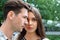 Beautiful pensive man and woman stand in park