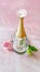 Beautiful perfume bottle and rose flower on marble background
