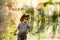 Beautiful photo about children. Boy in a cowboy hat catches a fish. Pond fishing.