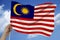 Beautiful photo of the national flag of Malaysia on delicate shiny silk with soft draperies, the concept of state power, country