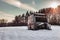 Beautiful photo of old and abandoned caravan in the middle of snow covered meadow in Winter time. Illuminated Caravan campervan