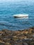 Beautiful photo of old white wooden vessel boat moored at ocean shore next to sharp cliffs