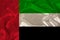 Beautiful photograph colored national flag of modern state United Arab Emirates on textured fabric, concept of tourism, emigration