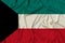 Beautiful photograph of the national flag of Kuwait on delicate shiny silk with soft draperies, the concept of state power,