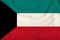 Beautiful photograph of the national flag of Kuwait on delicate shiny silk with soft draperies, the concept of state power,