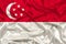 Beautiful photograph of the national flag of Singapore on delicate shiny silk with soft draperies, the concept of state power,