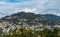 Beautiful photography of cityscape along side mountains under the cloudy blue sky